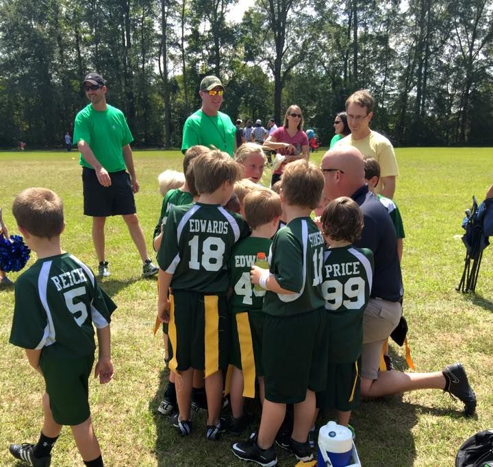 SJDS student huddling in a flag football game